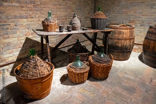 Ancient wine barrels and demijohns in a cellar. photo