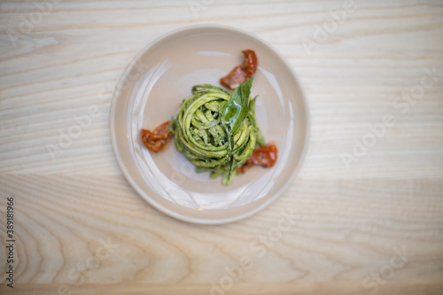 Above view of a zucchini noodles and spinach dish on a wooden table photo