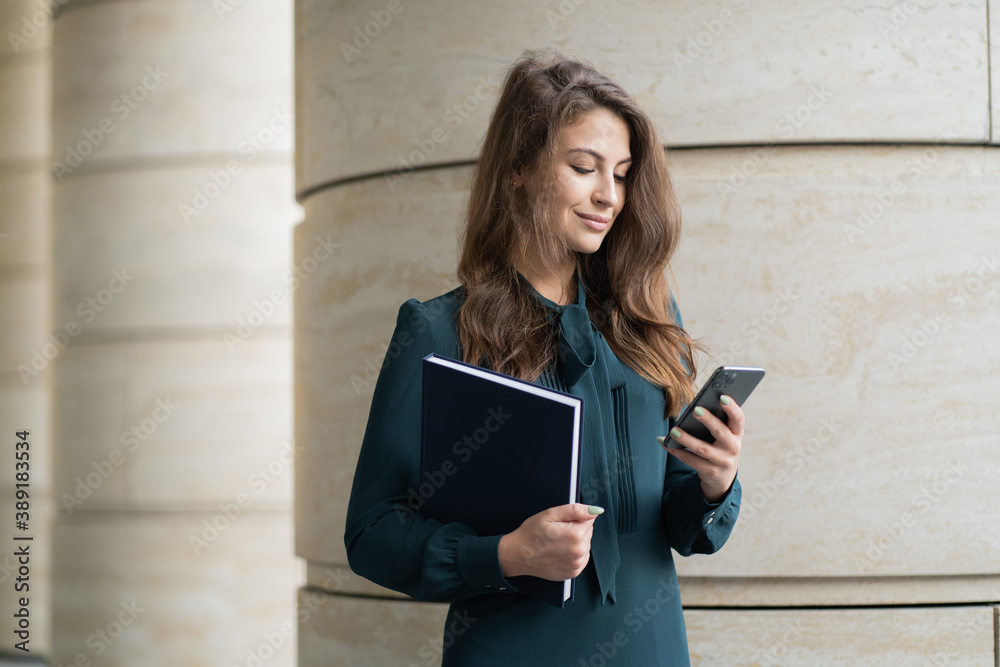 A woman in a formal dress is using the phone manager. A woman in a formal dress is using the phone manager.