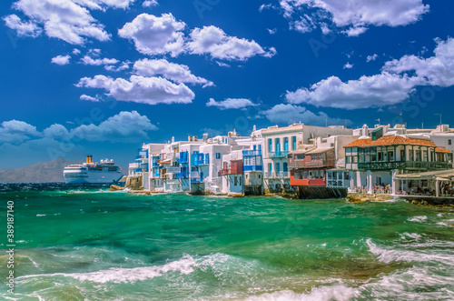 Fototapeta Naklejka Na Ścianę i Meble -  Little Venice, Mykonos island, Greece. Colorful buildings and balconies near the sea and a large white cruise ship.