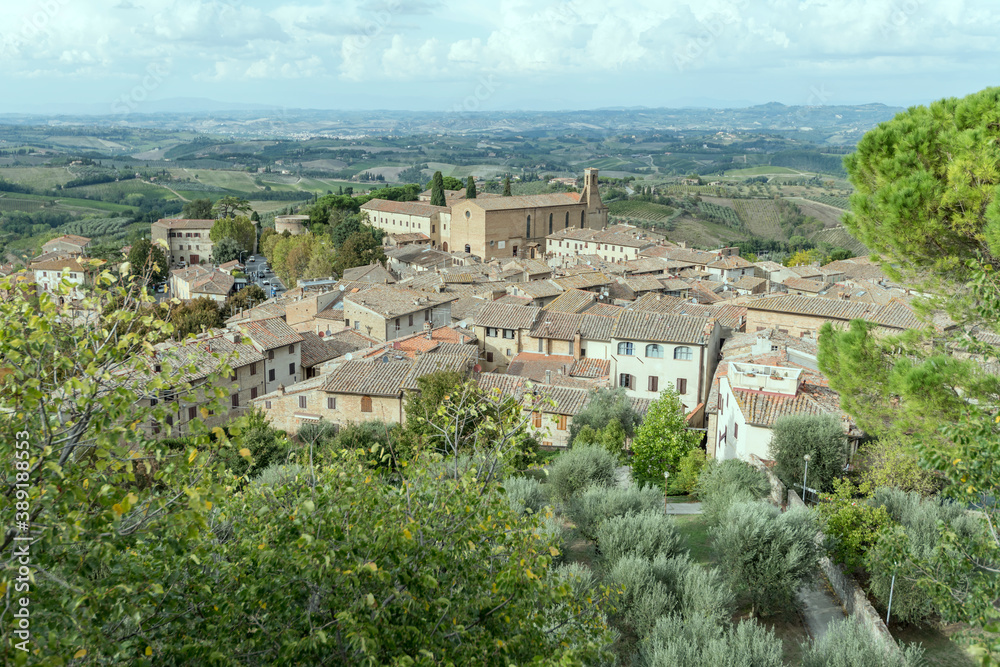 aerial cityscape with S.Agostino church and old roofs, San Gimignano, Siena, Italy