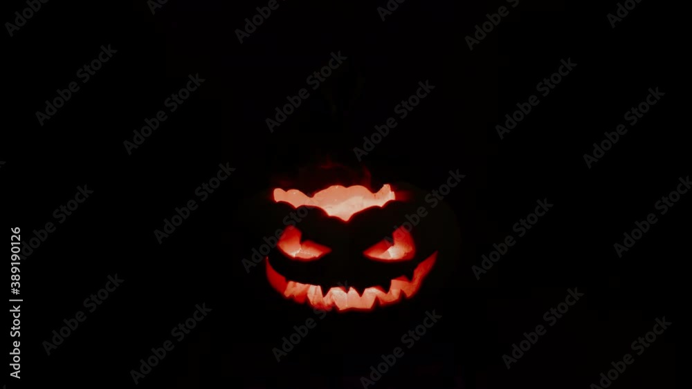 An evil pumpkin looks ahead. Jack is engulfed in hellfire.