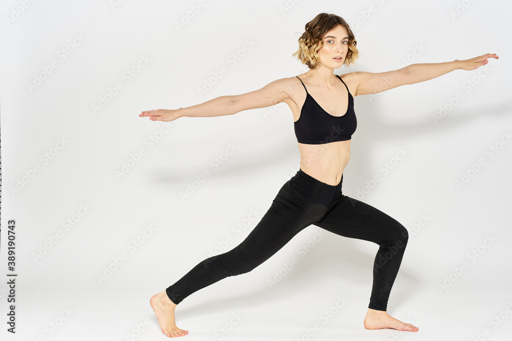 Woman in sportswear is engaged in fitness indoor gymnastics slim figure Woman in sportswear is engaged in fitness indoor gymnastics slim figure