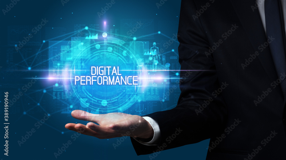 Man hand holding DIGITAL PERFORMANCE inscription, technology concept Man hand holding DIGITAL PERFORMANCE inscription, technology concept