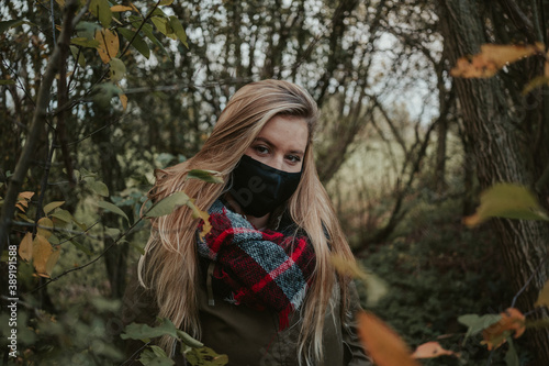 Woman with black mask in autumn Athomsphere protected from coronavirus