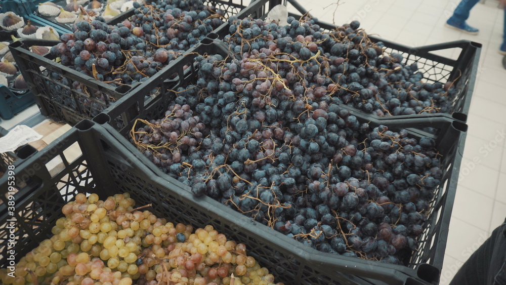 Blue grapes on the market in a basket.