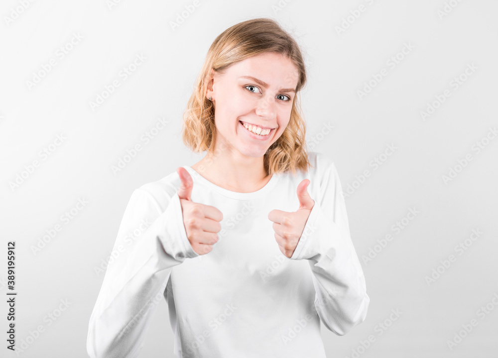 Young happy cheerful woman showing thumb up Young happy cheerful woman showing thumb up