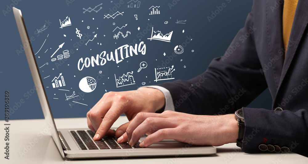 Businessman working on laptop with CONSULTING inscription, modern business concept Businessman working on laptop with CONSULTING inscription, modern business concept