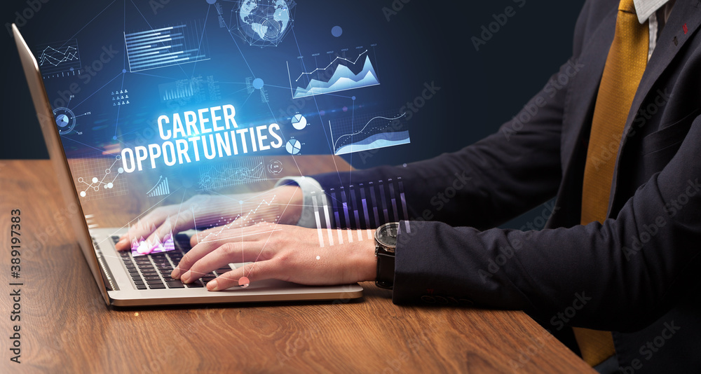 Businessman working on laptop with CAREER OPPORTUNITIES inscription, new business concept Businessman working on laptop with CAREER OPPORTUNITIES inscription, new business concept