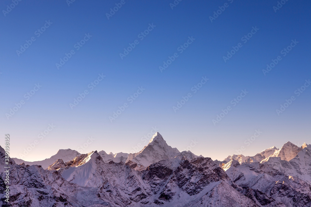 Himalayan mountain range with majestic morning light. Ama Damlam peak on everest base camp trek. Blue sky and beautiful mountains background.