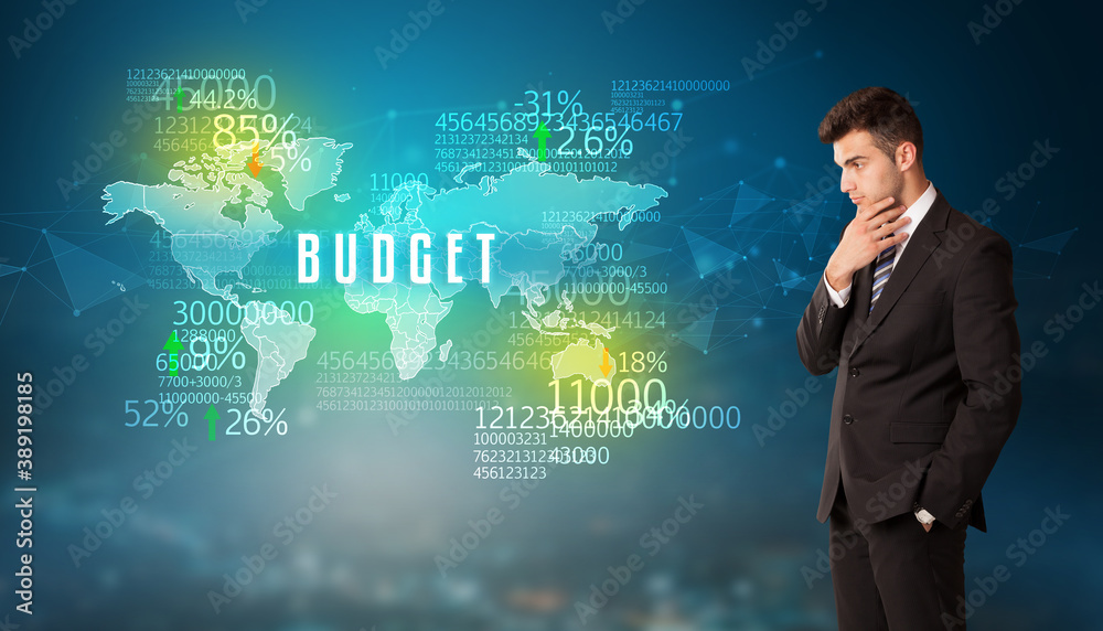 Businessman in front of a decision with BUDGET inscription, business concept Businessman in front of a decision with BUDGET inscription, business concept