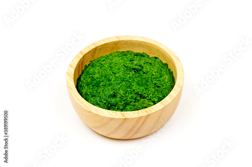 Neem leaf used as ayurvedic medicine on wooden bowl isolated on white background. Neem leaf is an excellent moisturizing and contains various compounds that have insecticidal and medicinal properties.
