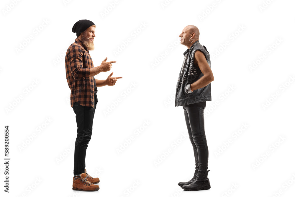 Full length profile shot of a bearded guy standing and talking to a punk in leather clothes Full length profile shot of a bearded guy standing and talking to a punk in leather clothes
