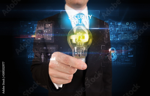 Businessman holding lightbulb with SECURITY POLICY inscription, online security idea concept