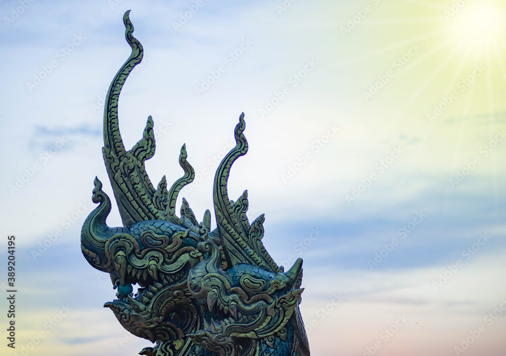 Naga head statue And the sky background at sunset time