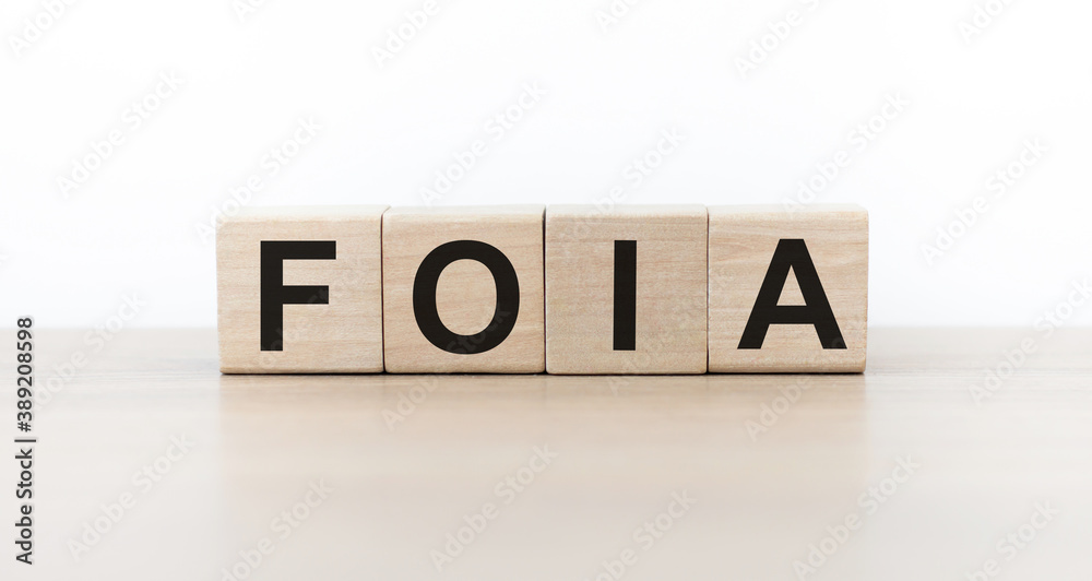 Word foia. Wooden cubes with letters isolated on light background with copy space available. Business Concept image. Word foia. Wooden cubes with letters isolated on light background with copy space available. Business Concept image.