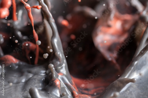 Lava bubbling inside a volcano - Black and red paint splashing creating lots of paint bubbles and droplets.