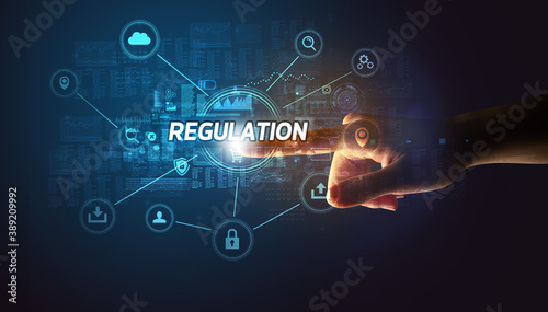 Hand touching REGULATION inscription, Cybersecurity concept