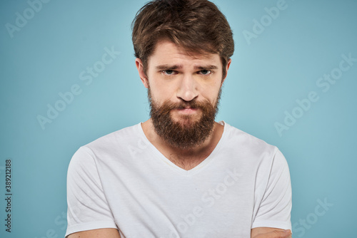 Man in white t-shirt emotions facial expression cropped view studio blue background lifestyle © SHOTPRIME STUDIO