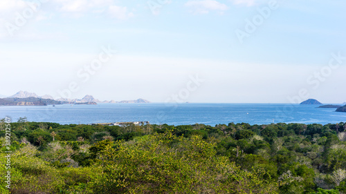 Viewpoint on Komodo Islands, bay view on a clear sunny day, calm sea bay and green forest