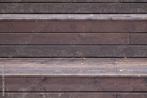 Wooden slats knocked tightly to each other in brown and gray color background for decorative pano or autumn composition. Eco materials for construction and decoration.