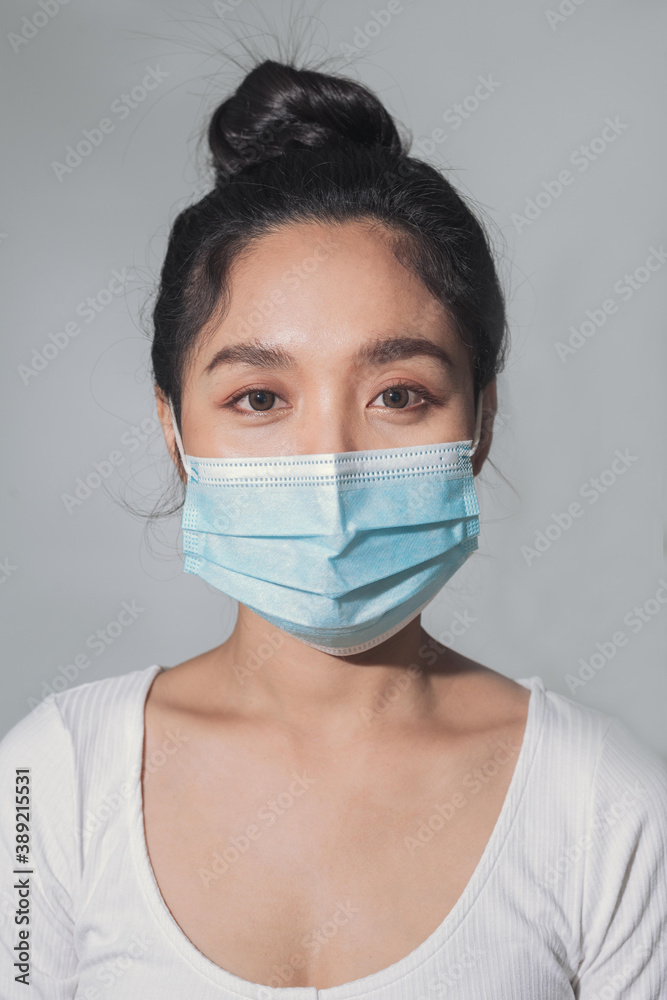 Woman wear medical mask protecting from coronavirus pandemic. close up of asian woman wear surgical medical mask.