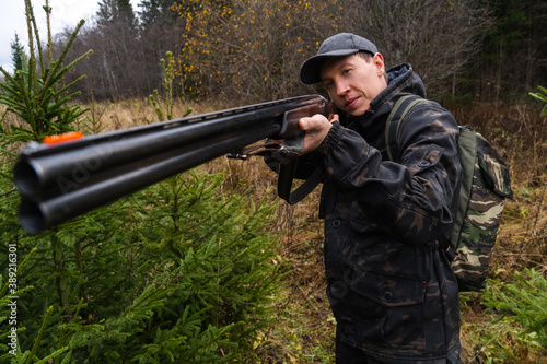 Hunter aiming a shotgun 