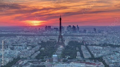 Panorama of Paris at sunset timelapse. Eiffel tower view from observation deck of montparnasse building in Paris - France. Colorful sky at summer day photo