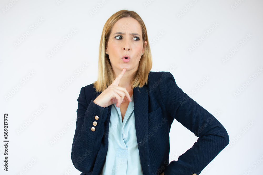 Portrait of young business woman pointing at white background