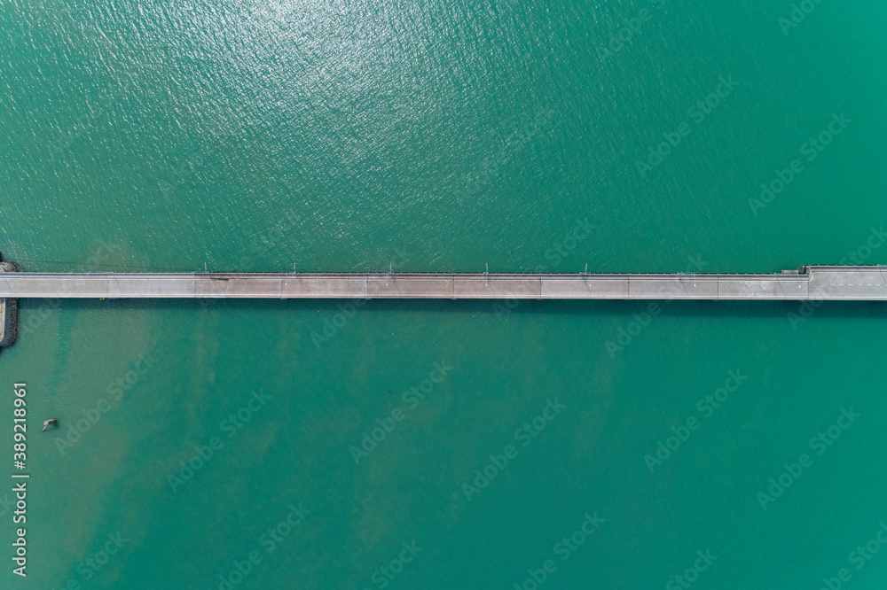 Aerial top view drone shot of small bridge in the sea image transportation background concept and travel design. Aerial top view drone shot of small bridge in the sea image transportation background concept and travel design.