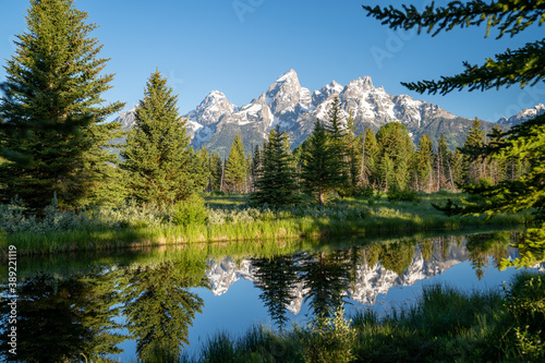 Schwabachers Landing in the early morning in Grand Teton National Park, with mountain reflections on the water creek © MelissaMN