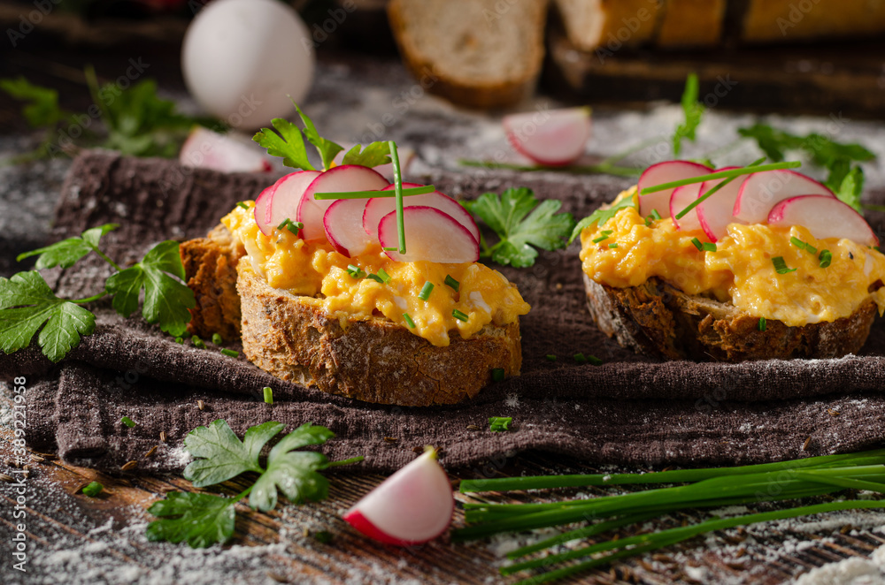 Delicious scrambled eggs on crispy bread Delicious scrambled eggs on crispy bread