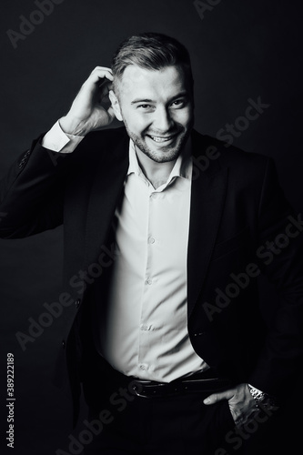 Handsome male businessman with suit posing in a photo studio. Half-length portrait