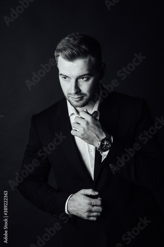 Handsome male businessman with suit posing in a photo studio. Half-length portrait