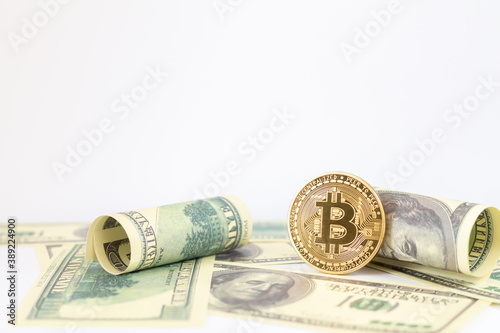 Gold bitcoin and US dollar banknotes isolated on white background
