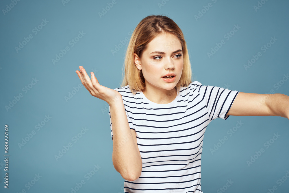 Upset woman emotions displeasure gestures with hands blue background Upset woman emotions displeasure gestures with hands blue background