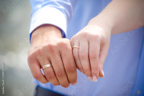 hands of married man and woman with rings photo