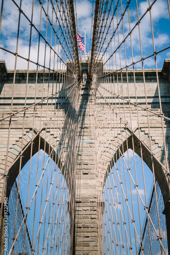 American flag flying over the Brooklyn Bridge