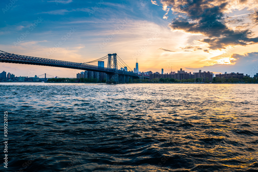 Cloudy evening sunset by the Manhattan bridge with a view of New York City skyline Cloudy evening sunset by the Manhattan bridge with a view of New York City skyline