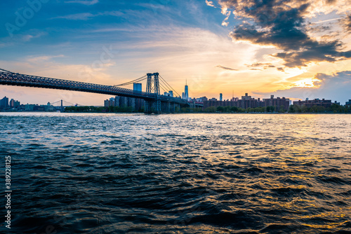 Cloudy evening sunset by the Manhattan bridge with a view of New York City skyline