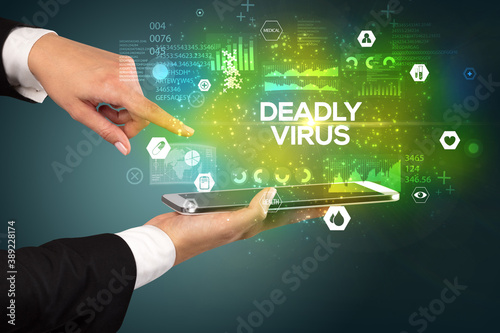 Close-up of a touchscreen with DEADLY VIRUS inscription, medical concept