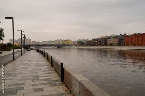 View of the panorama of the city of Moscow from the Crimean embankment. Walking along the river on the pavement in cloudy autumn weather.