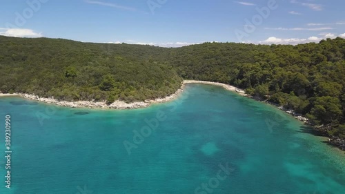 Aerial view on the beautiful bay on Rab island in Croatia. Quick pull back shot.