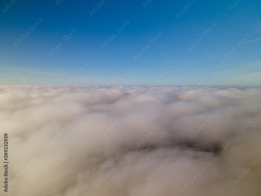 Above the clouds. Flight through the clouds in the morning. Fog, sky, thick clouds.