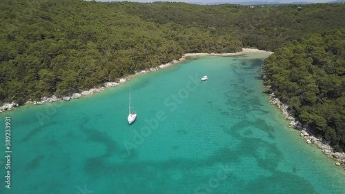 Drone view of bay with turquoise water and luxurious yacht, Rab island, Croatia.