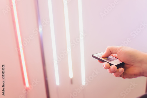 LED strip in purple colors and a control panel for switching colors. photo