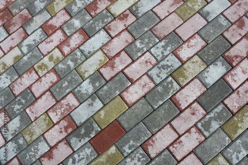 The texture of colored paving slabs on a street base. Concrete pavement