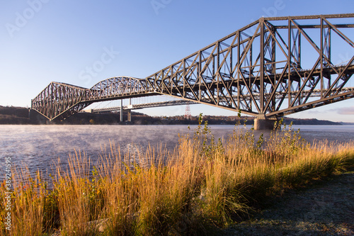 Beautiful early morning view of the 1919 steel Quebec Bridge over the St. Lawrence river seen from the Samuel-de-Champlain Walk on the north shore, Quebec City, Quebec, Canada