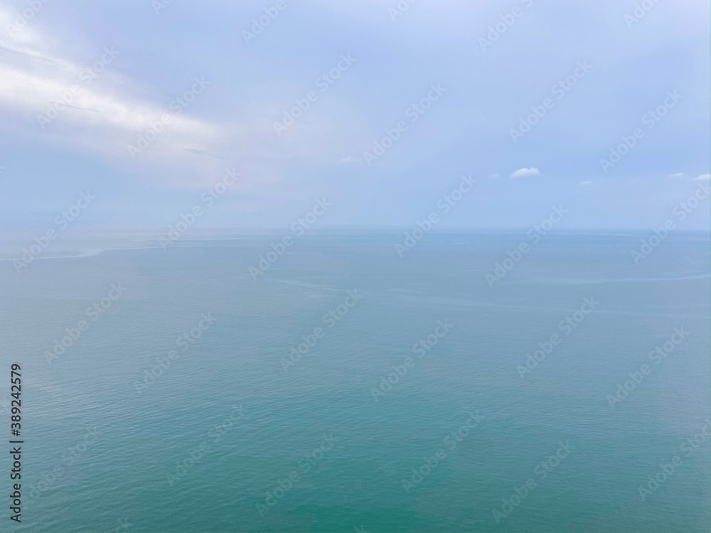 seascape background show sea and bright blue sky with cloud in winter and small calm wave and silhouette bird fly seascape background show sea and bright blue sky with cloud in winter and small calm wave and silhouette bird fly