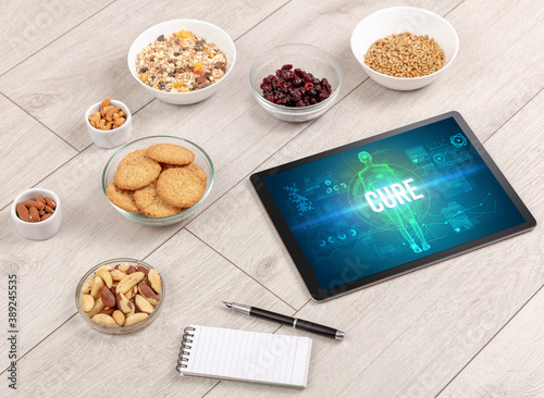 CURE concept in tablet with fruits, top view